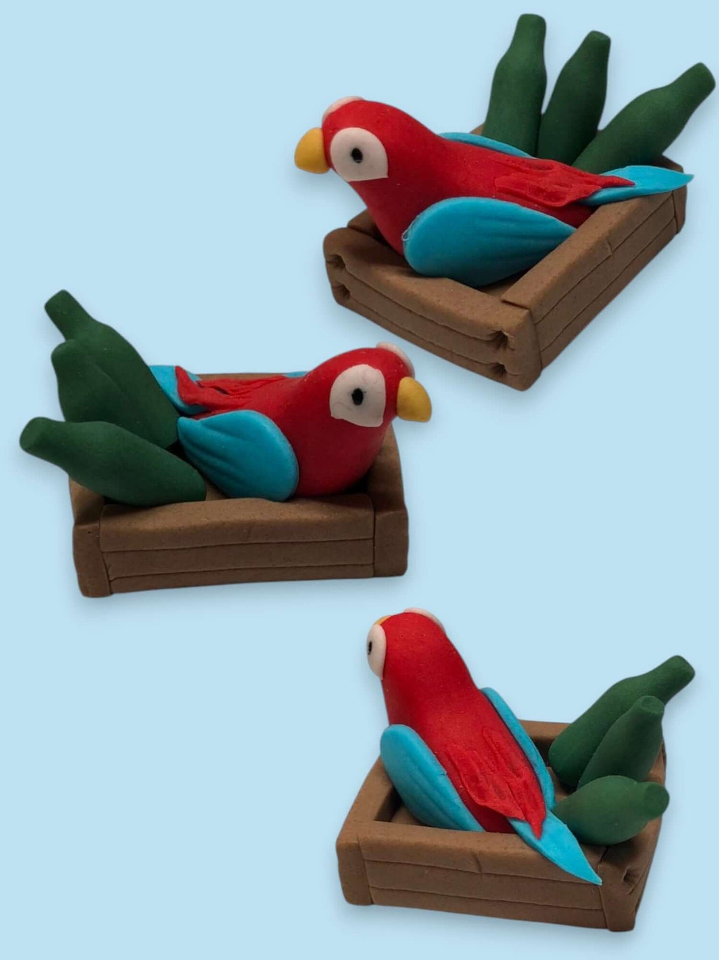 handmade fondant icing parrot and bottles in a crate