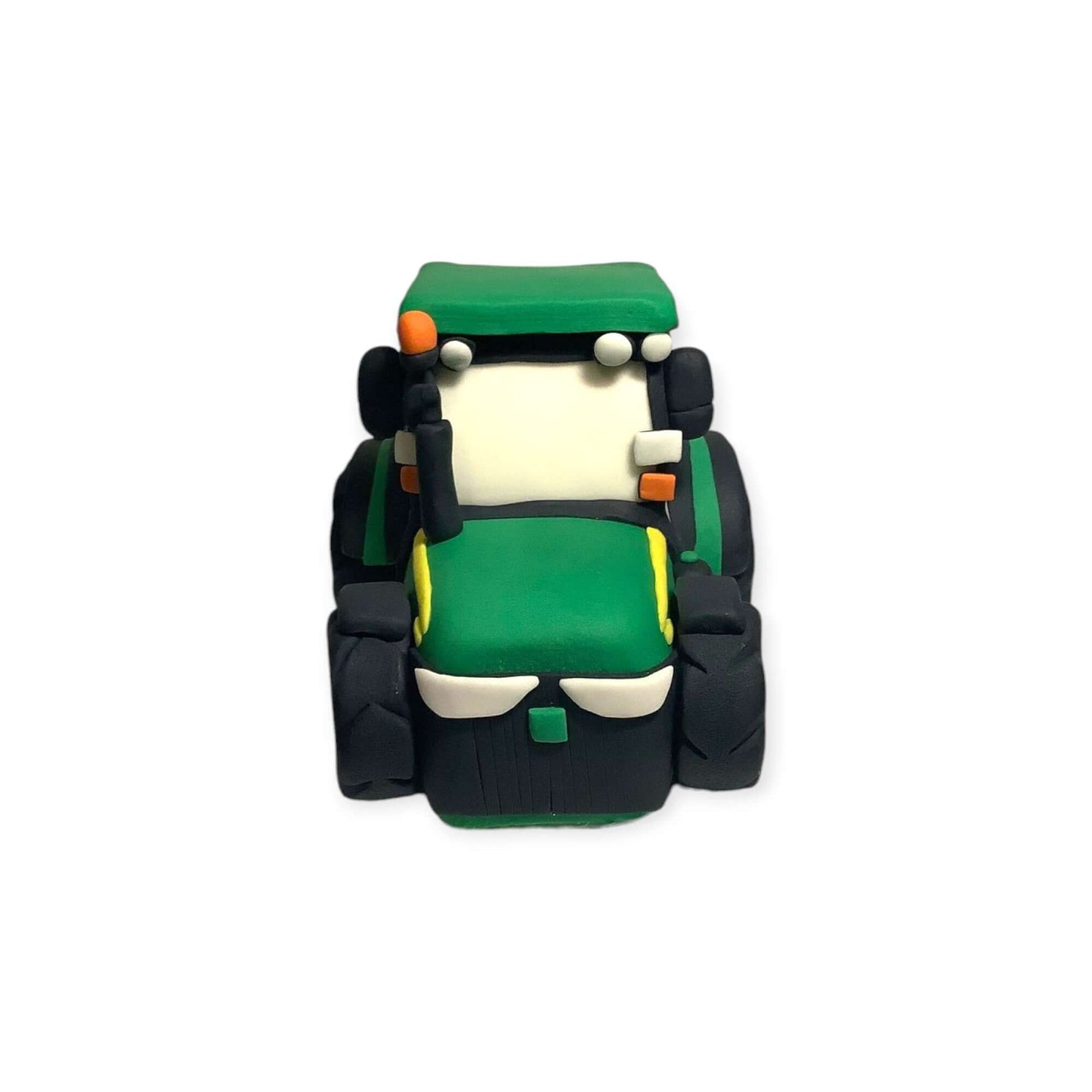 Front view of a detailed handmade fondant tractor figurine 