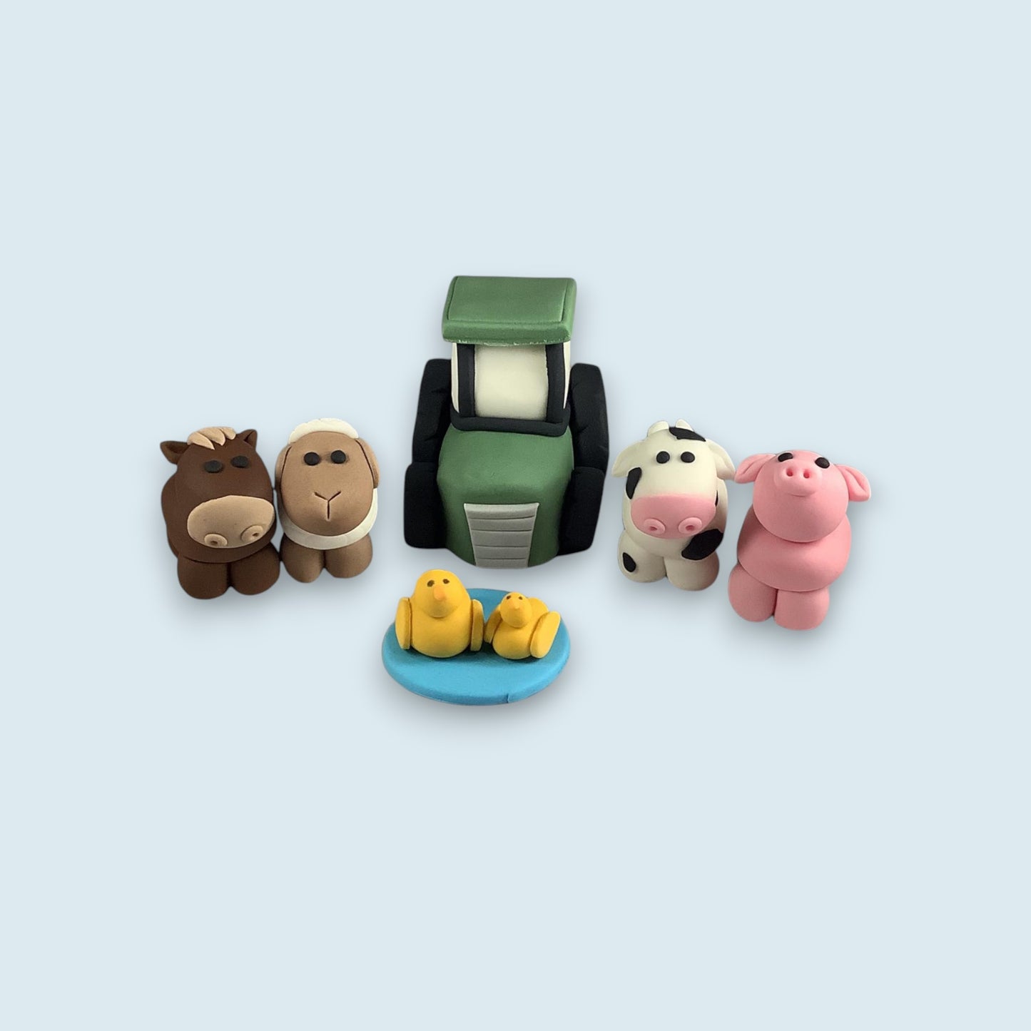 tractor with horse, sheep, cow, pig and two ducks handmade from fondant icing 