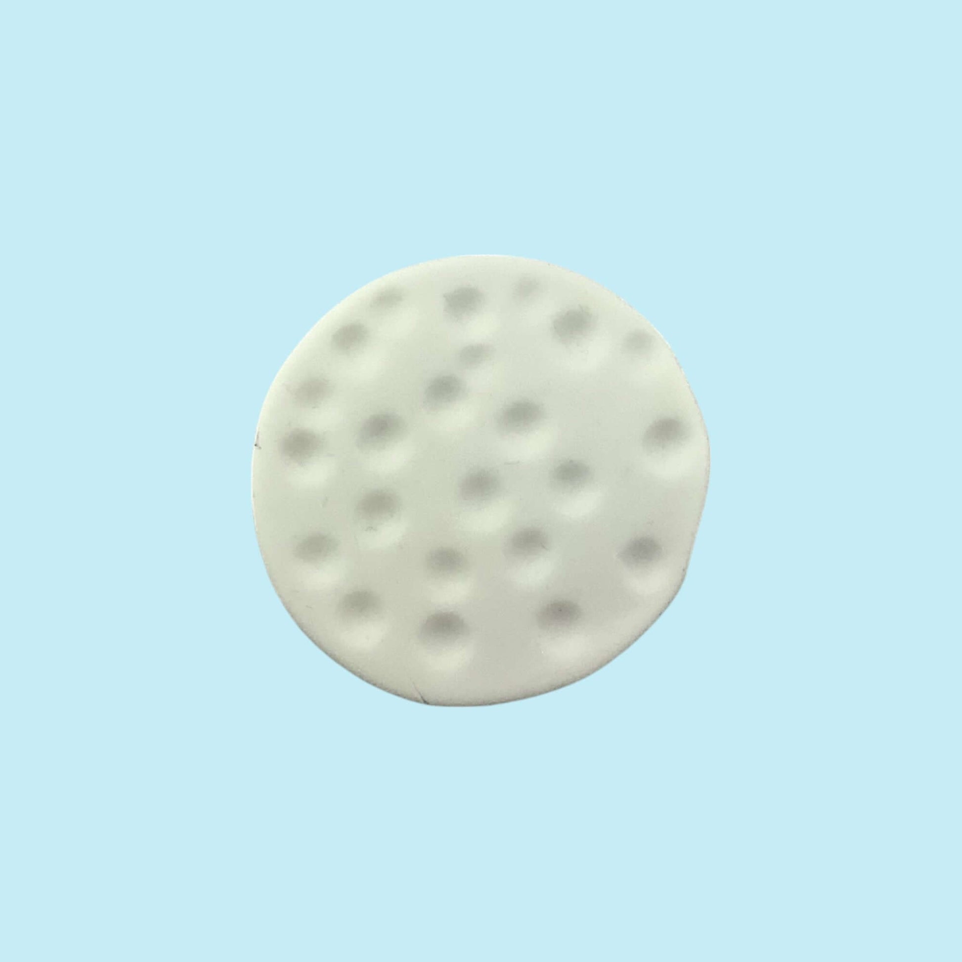 Round white golf ball cupcake topper on a light blue background 